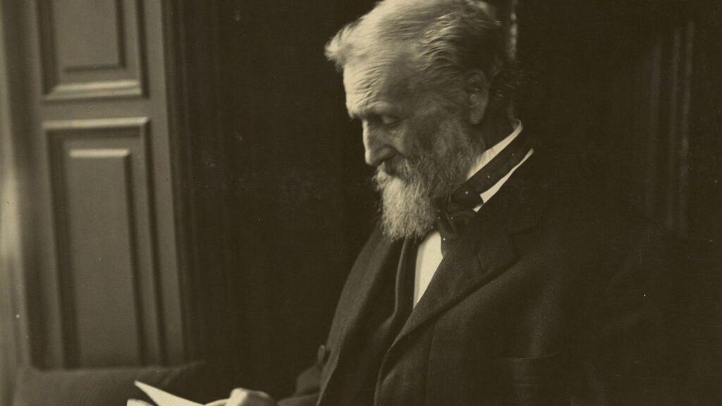 A man Reading a Book wearing a black suit