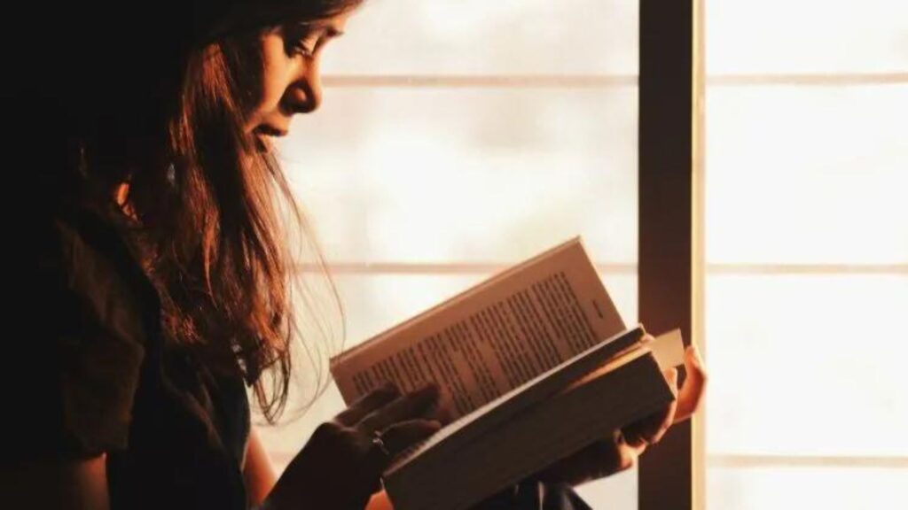 A Woman Reading a Book in a Library